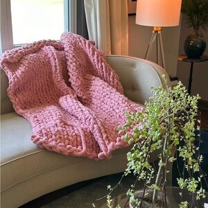 Handmade chunky knit pink adult throw.